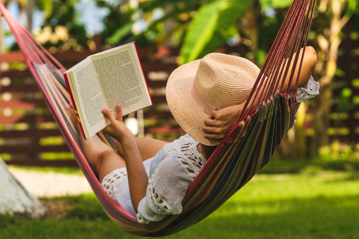 Woman reading book in hammock
