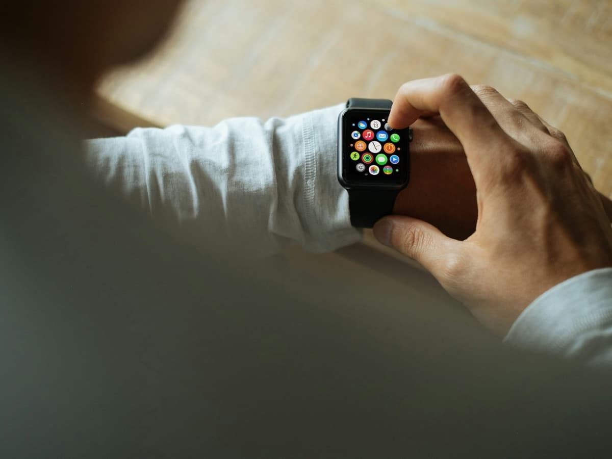 A person tapping an Apple Watch on their wrist