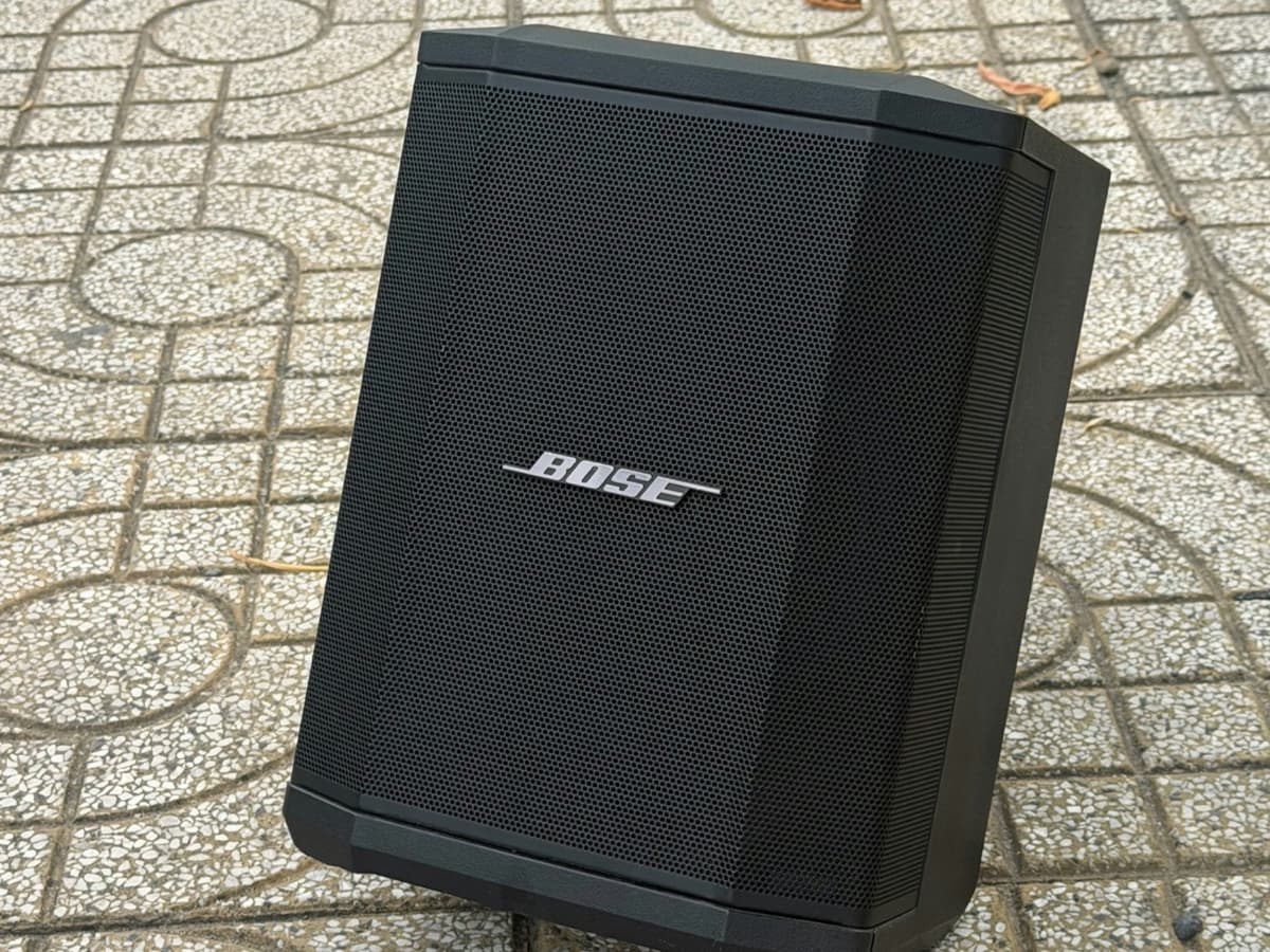 A large portable PA-style party speaker standing on paving outdoors